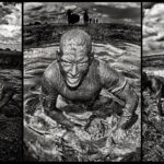 A black-and-white triptych depicts a man crawling through mud and water. In each panel, he is covered in mud, with a determined smile. The background features an open field, scattered clouds, and people in the distance. The middle panel shows him emerging from a muddy puddle.