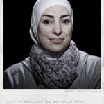 A portrait features a woman wearing a white headscarf and patterned scarf. She is looking directly at the camera with a slight smile. Text below the image reads: “Miada, Age: 39, Syria. I wish that the war would stop.”.