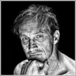 Black and white portrait of a man with light hair, looking directly at the camera. His face shows an expressive, thoughtful gaze and is marked with visible lines and texture. His chin rests on his hand, and the background is deeply darkened, almost black.